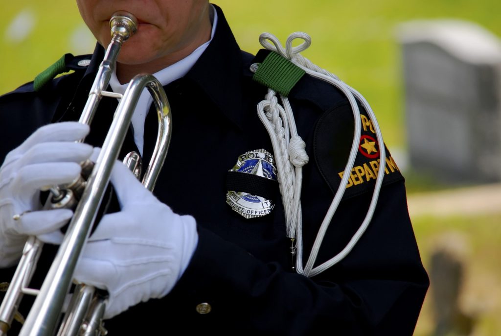 Police officer playing bugle at funeral Police officer playing bugle at funeral