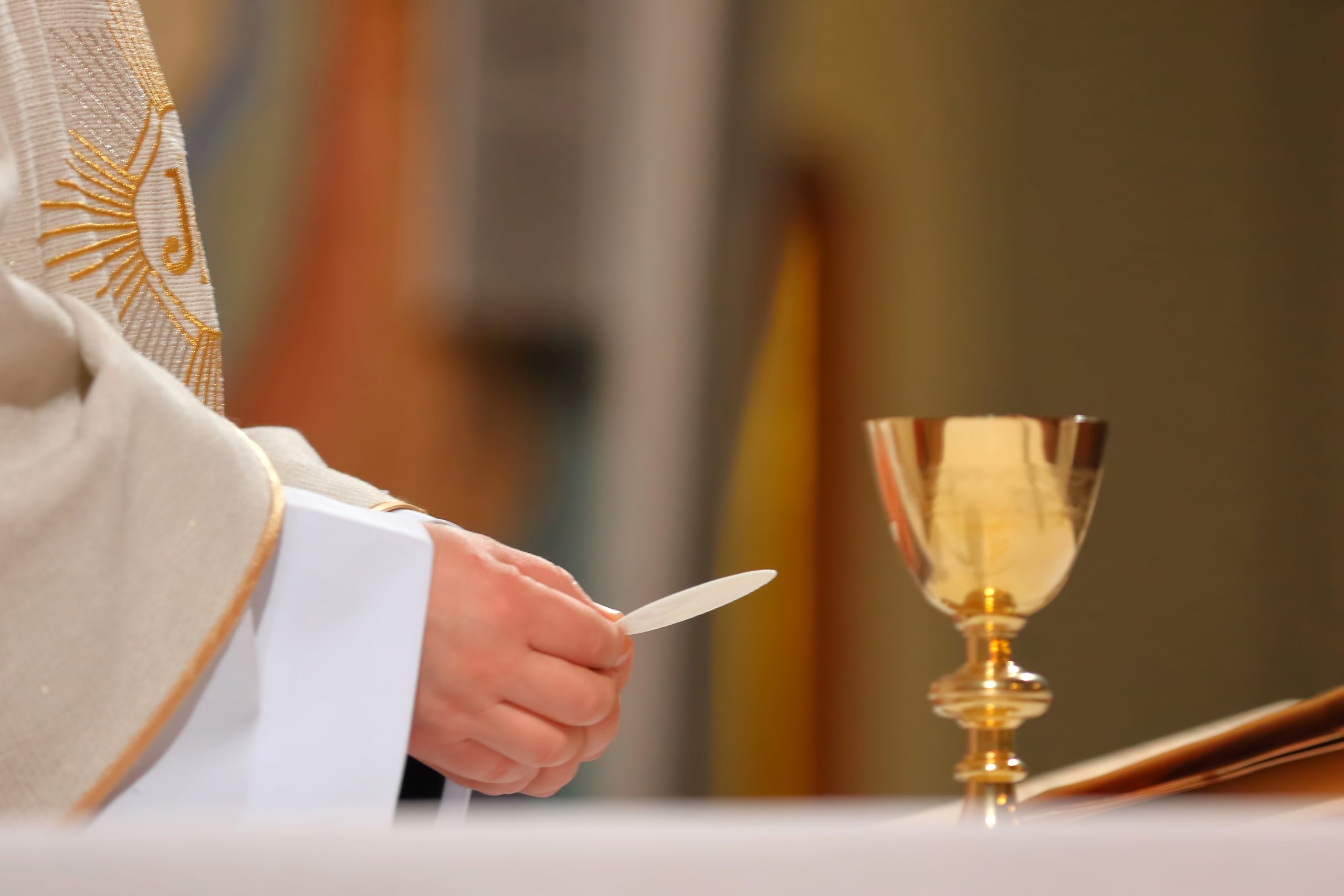 Priest holding holy communion Priest holding holy communion
