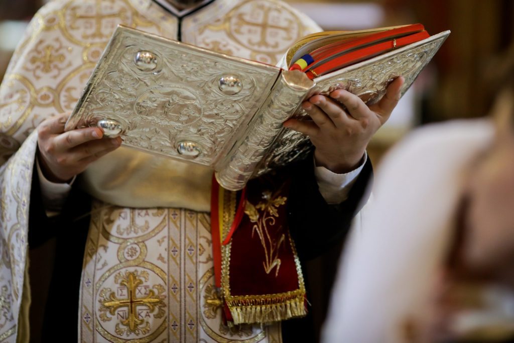 Priest holding bible Priest holding bible